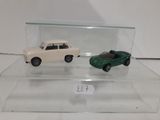 two toy cars that are on display in a glass case