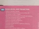 packaging of a pink box with instructions for radio - revel avce projection