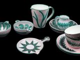 a tea set with a cup and saucer on a black background