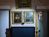 an image of a living room with a television and paintings on the wall