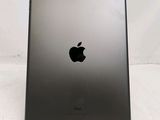 an apple ipad is sitting on a stand on a white surface