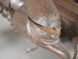a close up of a wooden bench with a piece of wood sticking out of it