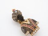 an image of a gold and diamond broochle with a black face