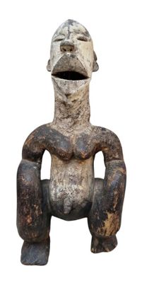 an old statue of a man sitting on a chair with his hands on his knees