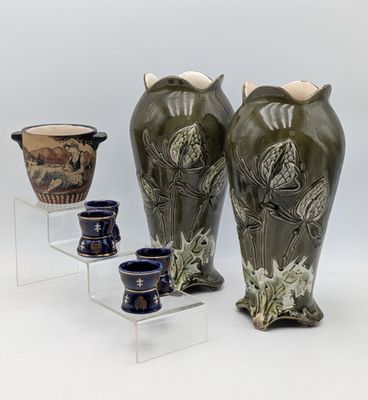 three vases that are sitting on a clear shelf