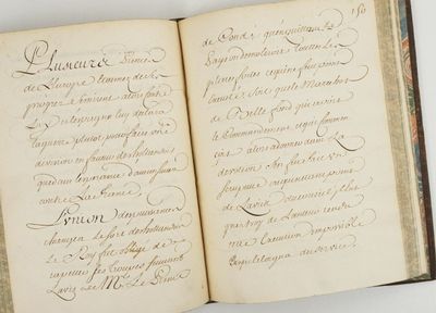 an open book with writing on it sitting on a table