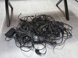 a pile of wires on the floor next to a table
