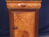 a small wooden cabinet with a green top on a table