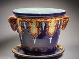a purple and blue cup with a saucer on a saucer