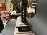 someone is taking a picture of a sculpture of a man standing on top of a table