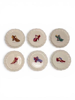 six plates with different designs of shoes on them on a white surface