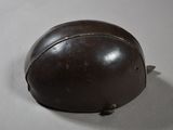 a brown helmet on a white table with a white background