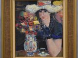 portrait of a woman in a straw hat with flowers in a vase