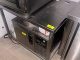 a microwave sitting on top of a table in a kitchen
