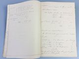 an open book with handwriting on it sitting on a blue surface