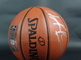 a close up of a basketball on a table with a black background