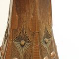 a brown vase that has a gold decoration on it
