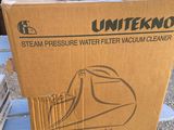 cardboard box sitting on top of a table with a vacuum cleaner on it