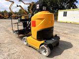 a small yellow machine that is parked in the dirt
