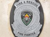 a fire and rescue badge on the side of a fire hydrant