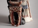 a figurine of a woman sitting on top of a table