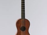 a small wooden guitar hanging from the ceiling