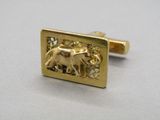 an image of a close up of a gold cuff with an elephant on it