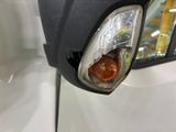 a close up of a car ' s headlight and side mirror