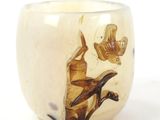 a picture of a glass cup with a bird and a bird on it