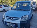 a small blue van parked in a parking lot