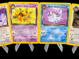four pokemon cards are lined up in a row on a black background