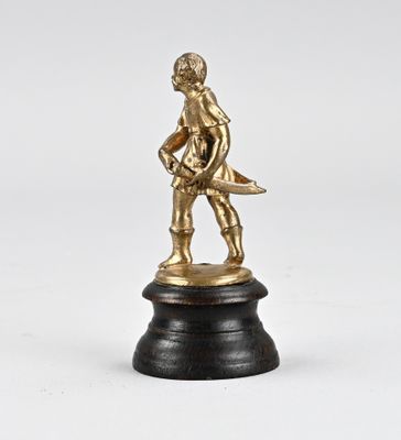brass figurine of a boy holding a fish on a black base