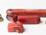 several pieces of red soap sitting on top of a white surface
