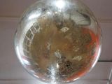 a glass ball hanging from the ceiling in a room