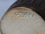 a close up view of a vase with a brown base