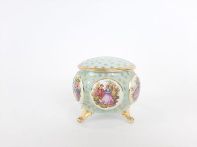 a small blue and white vase with flowers on it