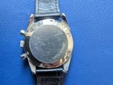 an image of a close up of a wrist watch on a blue surface