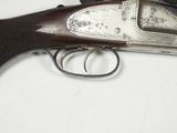 an old gun is laying on a white surface with a white background