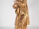 gold statue of a man holding a baby in his arms