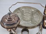 a silver plate with a silver lid and a silver spoon and a silver plate with a silver spoon and a silver plate with a silver spoon and a silver