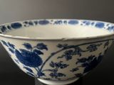 a blue and white bowl sitting on a black table