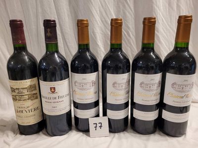 six bottles of red wine are lined up on a table