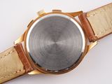 a close up of a watch on a white surface