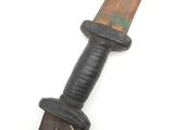 a knife with a wooden handle on a white surface