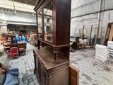 a large wooden cabinet in the middle of a room