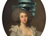 portrait of a woman wearing a blue hat with a large feather on it