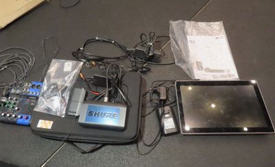 a tablet computer sitting on top of a table next to a tablet computer