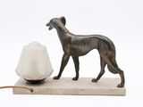 a statue of a dog and a lamp on a table