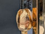 a gold spoon and spoon rest on a silver plate