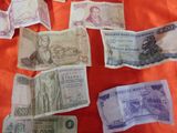 many different bank notes laid out on a table
